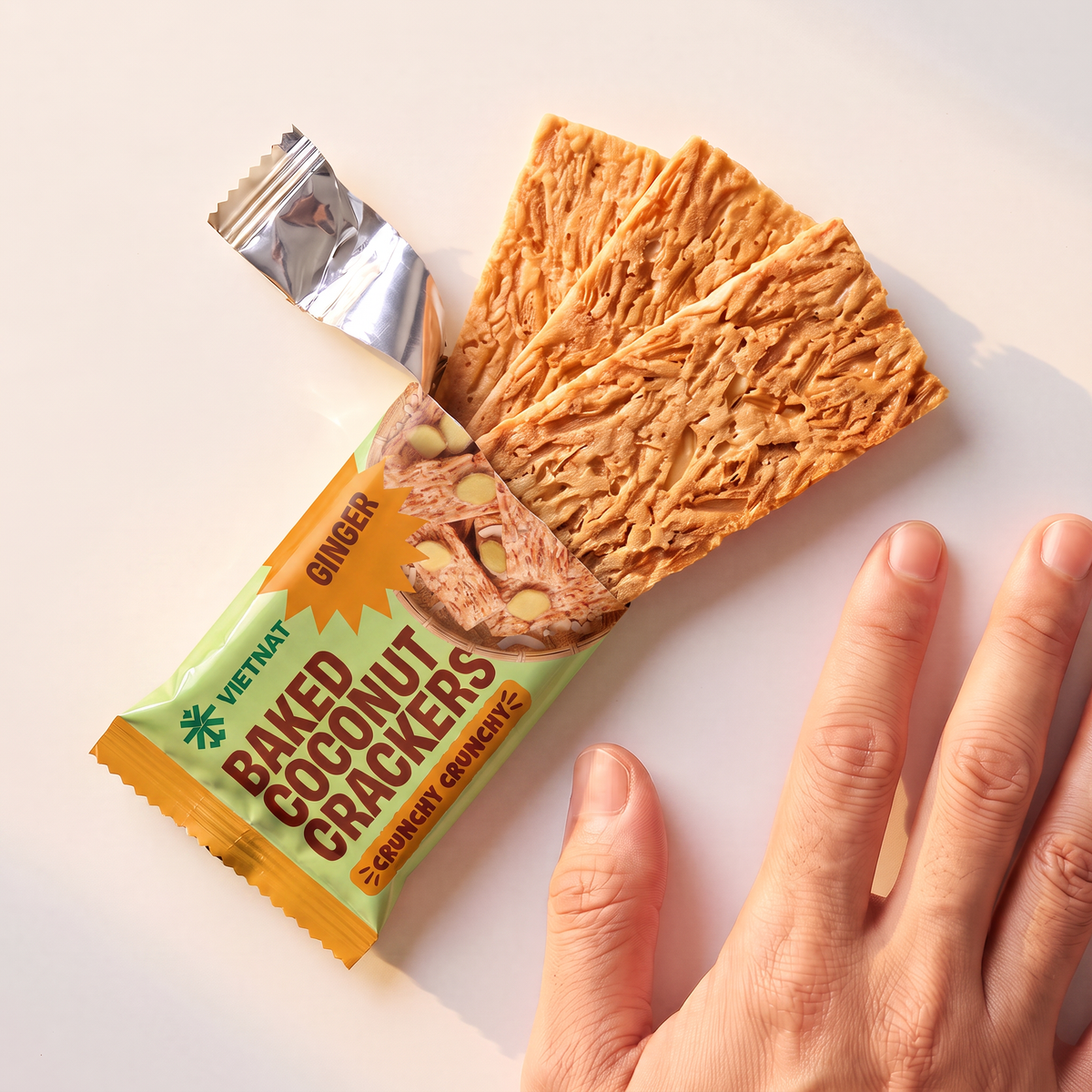 One snack pack and crackers shown next to a hand for size, Ginger