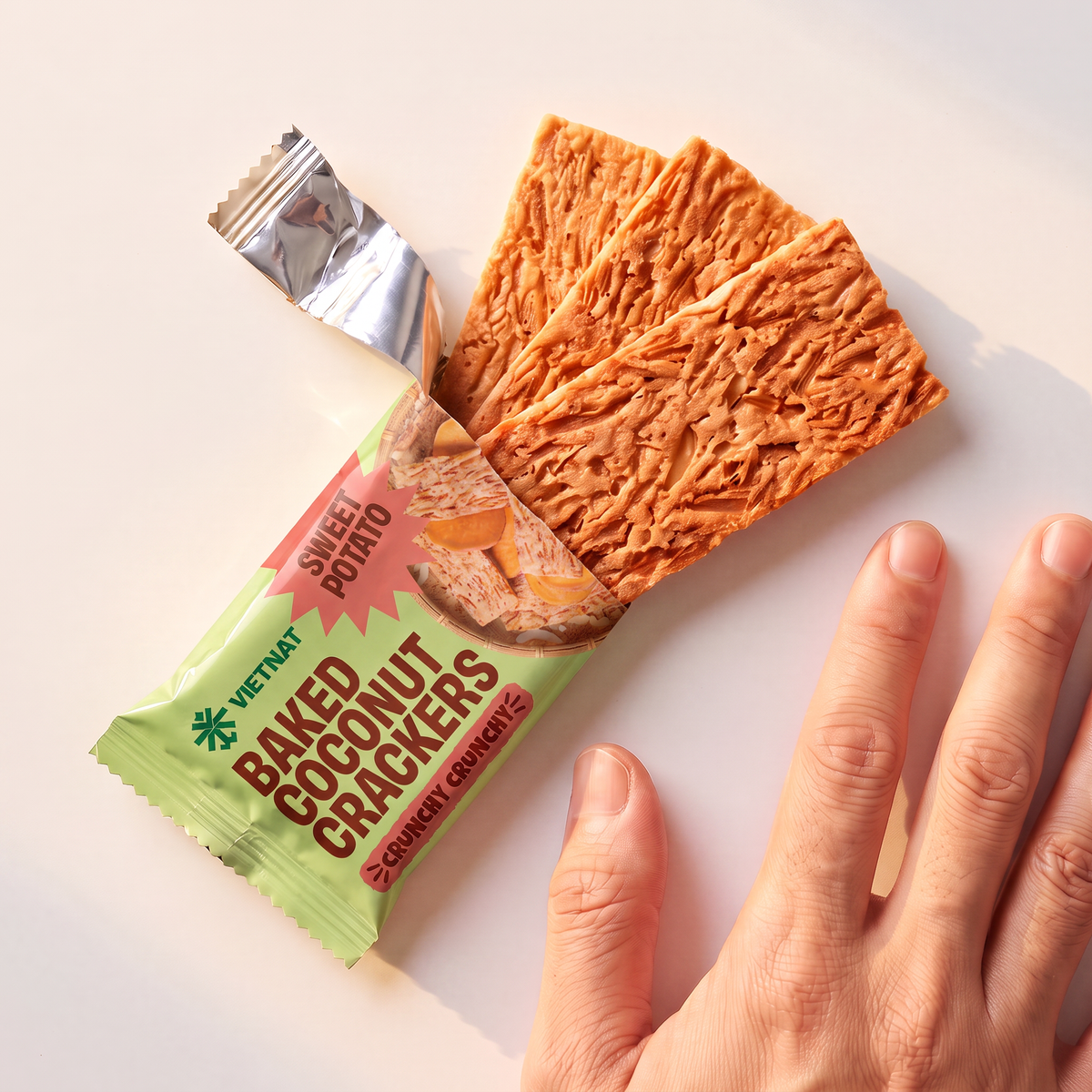 One snack pack and crackers shown next to a hand for size, Sweet Potato