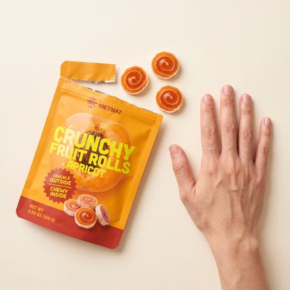 VietNat apricot rolls next to a hand for size