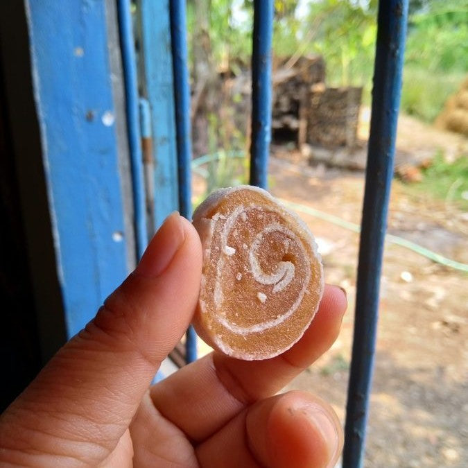 A real soursop fruit roll held between two fingers
