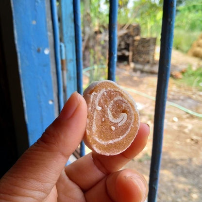 A real soursop fruit roll held between two fingers
