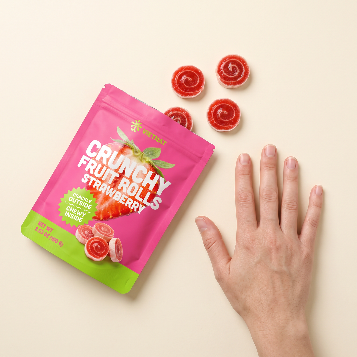 VietNat strawberry rolls next to a hand for size