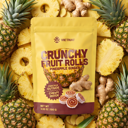 VietNat Crunchy Pineapple Ginger Fruit Rolls bag among ripe pineapple and fresh ginger