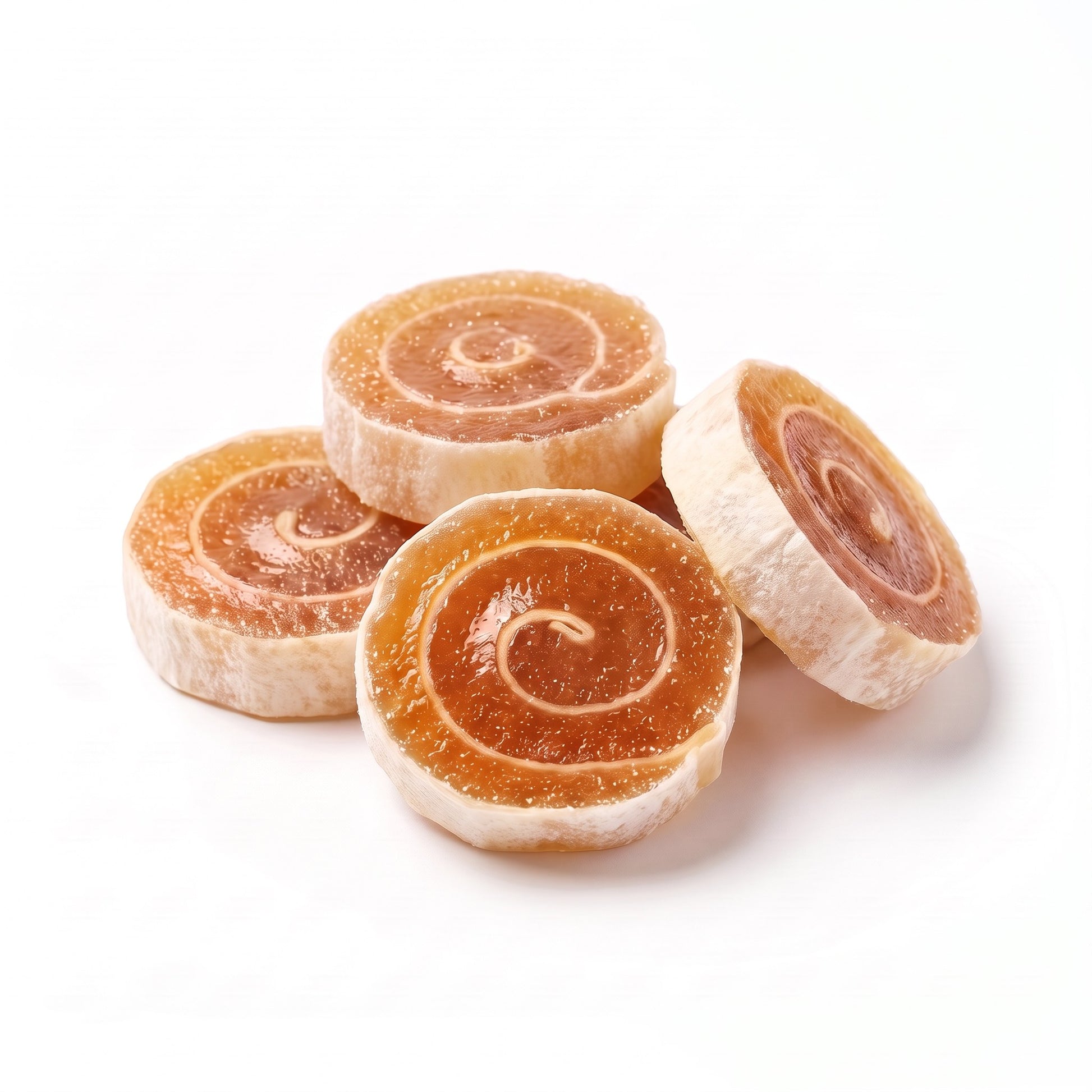 Crispy pineapple fruit rolls on white showing the rust-orange spiral
