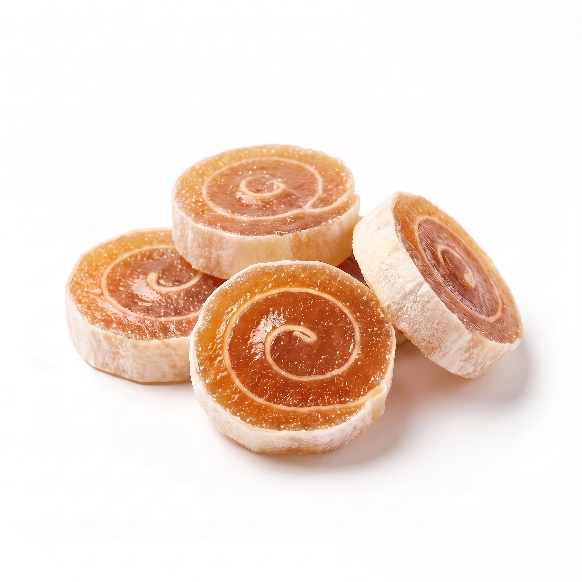 Four crispy pineapple fruit rolls on white showing the amber jelly face