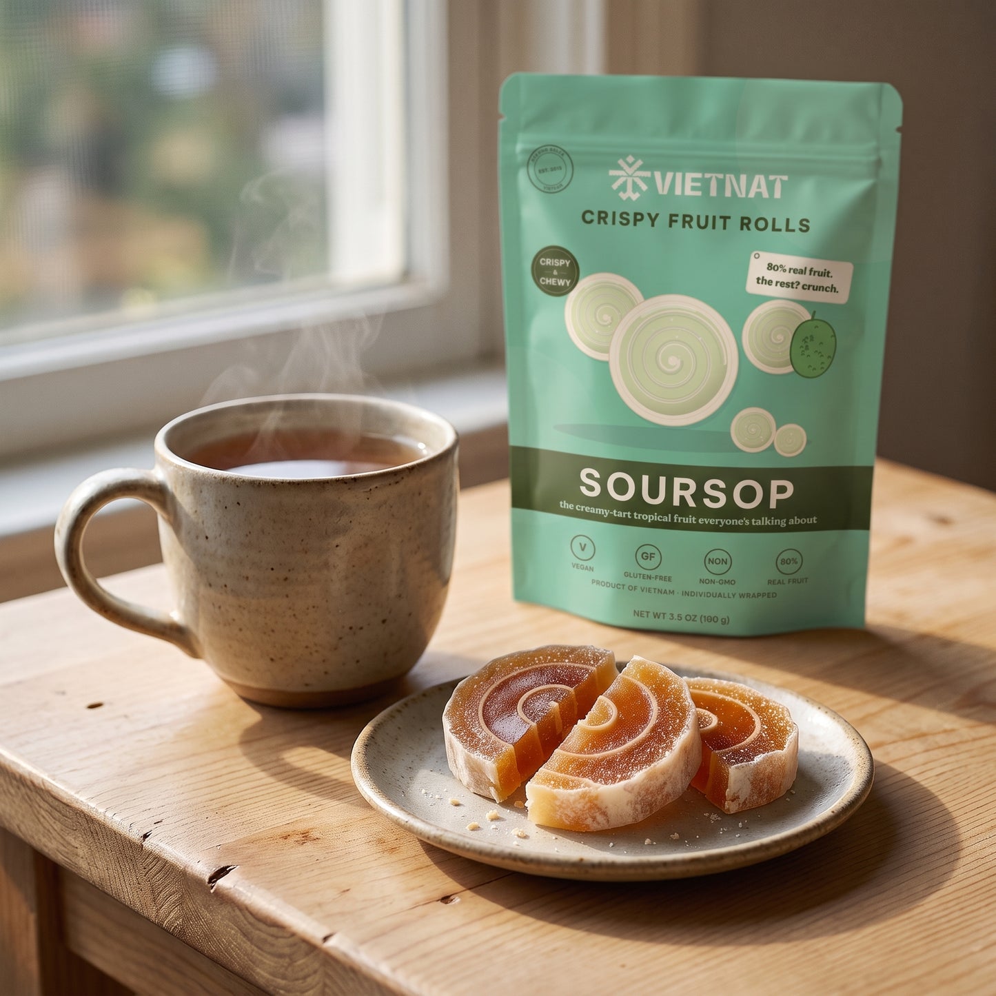 Three bite-size crispy soursop fruit rolls on a saucer beside a mug of hot tea